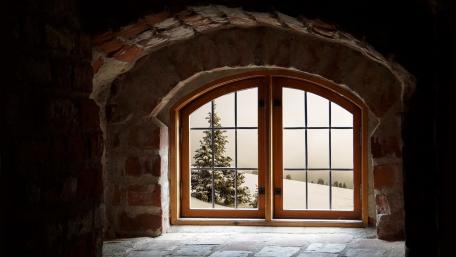 Winter Serenity Through a Cozy Window View wallpaper