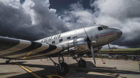 Vintage Airplane Against Dramatic Sky wallpaper