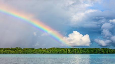 Vibrant Rainbow Above Serene Waters wallpaper