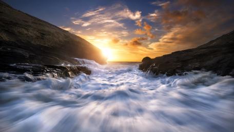 Serenity of Sunset by the River Flowing Fast wallpaper