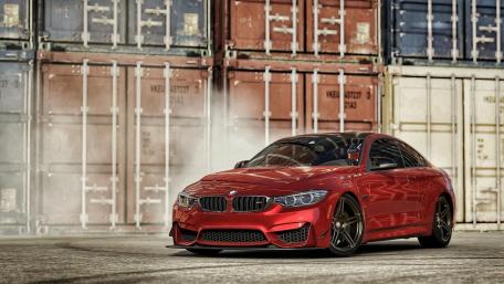 Sleek Red BMW Among Urban Backdrop wallpaper