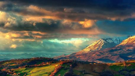 Majestic Peaks and Rolling Countryside wallpaper