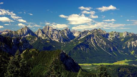Majestic Alpine Peaks Under a Blue Sky wallpaper