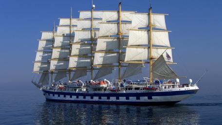 Elegant Tall Ship Sailing Across Tranquil Waters wallpaper