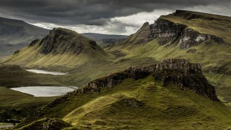 Majestic Mountains Under a Cloudy Sky wallpaper