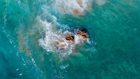Aerial View of Rocks in Turquoise Sea wallpaper