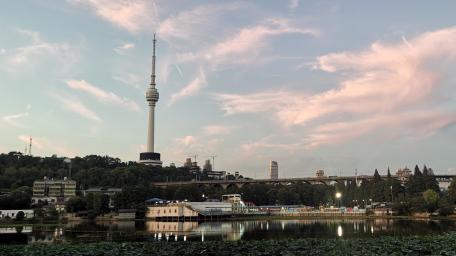 Serene Cityscape at Dusk Over a Calm Water Body wallpaper