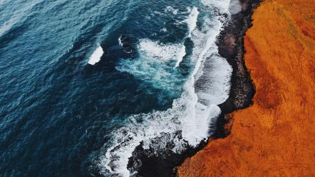 Serene Aerial View of Ocean Meeting the Coastline wallpaper