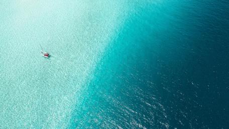 Tranquil Blue Waters and Sailboat View wallpaper