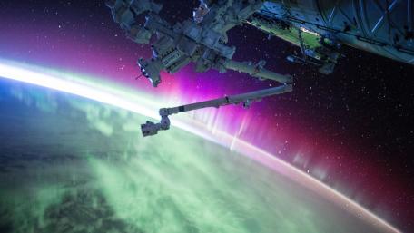 Vibrant Aurora Borealis Above Earth from Space Station wallpaper