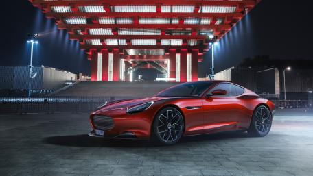Sleek Red Supercar Under Neon Lights wallpaper