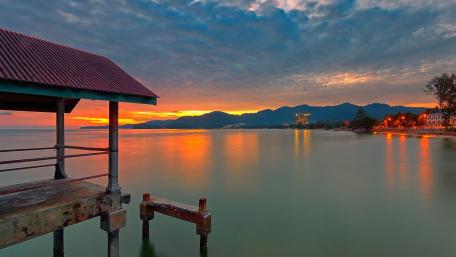 Serene Sunset Over Calm Lake Waters wallpaper