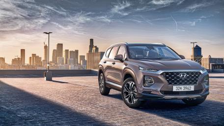 Sleek Hyundai Santa Fe Against Urban Skyline View wallpaper
