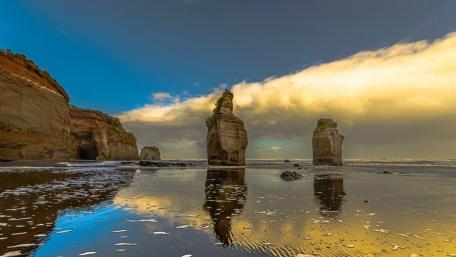 Majestic Sea Stacks Amidst Tranquil Waters wallpaper