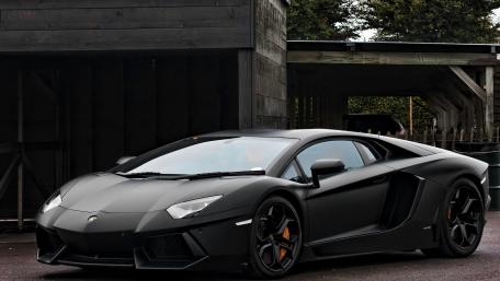 Sleek Elegance Black Lamborghini in Motion wallpaper