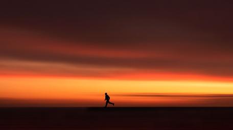 Chasing Dreams Beneath an Orange Sky wallpaper