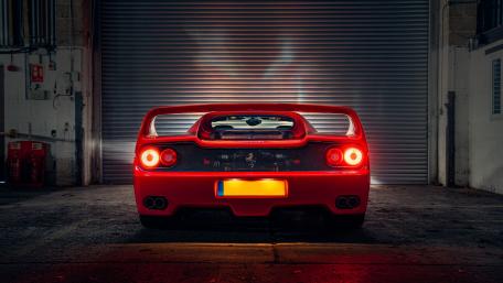Gleaming Red Ferrari F50 Under Lights wallpaper
