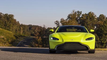 Vibrant Aston Martin Vantage on Scenic Roadway wallpaper