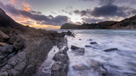 Serene Rocky Coastline at Sunset wallpaper