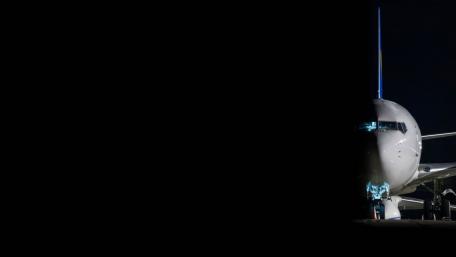 Sleek Airplane Against Black Background wallpaper