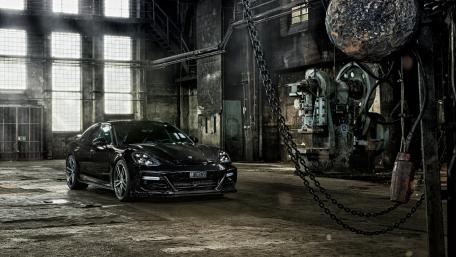 Sleek Black Porsche Panamera in a Gritty Setting wallpaper