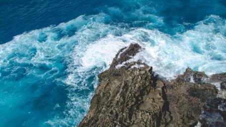 Majestic Cliffs Overlooking Vibrant Blue Sea wallpaper