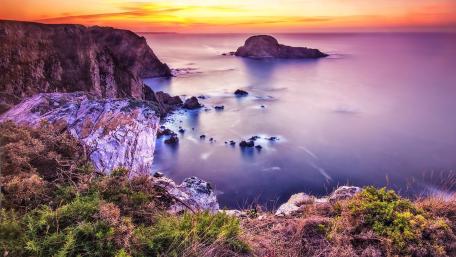 Tranquil Sunset Over Coastal Cliffs and Tranquil Waters wallpaper