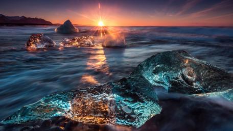 Glowing Ice at Sunset Over the Sea wallpaper
