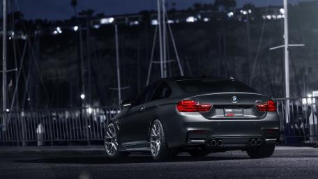Sleek BMW Under City Lights at Night wallpaper