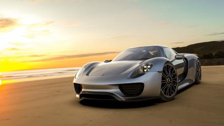 Sleek Porsche 918 Spyder at Sunset Beach Scene wallpaper