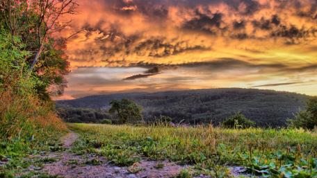 Stunning Sunset Over Rugged Terrain wallpaper