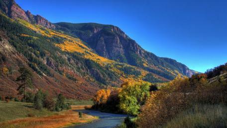 Majestic Autumn Landscape with River and Mountains wallpaper