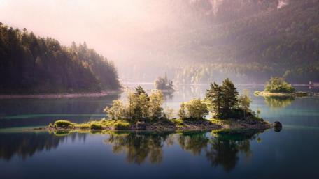 Serene Islets Enveloped by Misty Lake Views wallpaper