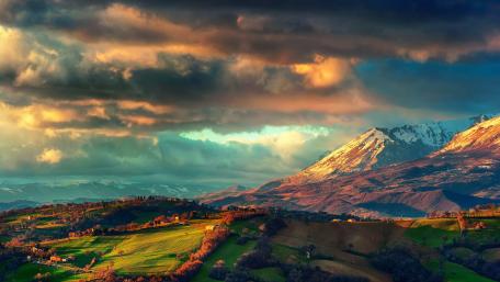 Majestic Mountain Landscape Under Dramatic Clouds wallpaper