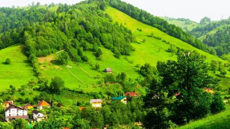 Tranquil Village Amidst Lush Green Hills wallpaper