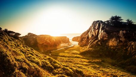 Golden Sunlight Over Coastal Landscape wallpaper