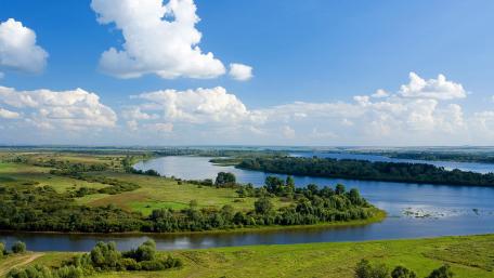 Tranquil River Under a Blue Sky wallpaper