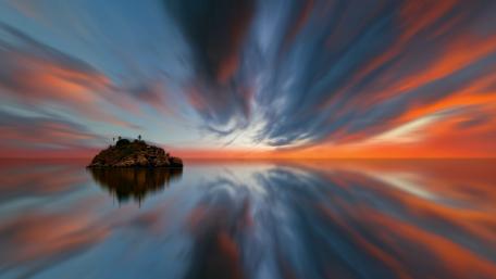Serene Sunset Reflection Over an Island wallpaper