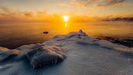 Golden Sunrise Over Frozen Shoreline wallpaper