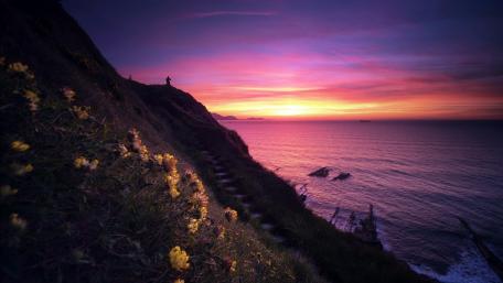 Serene Sunset Over Tranquil Sea Shoreline wallpaper