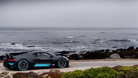 Sleek Bugatti Divo by the Ocean Shoreline wallpaper