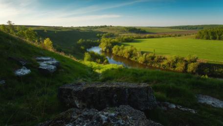 Serene River Landscape Amidst Lush Greenery wallpaper