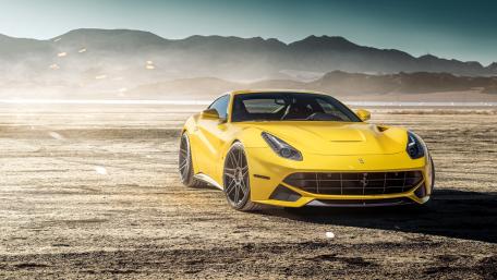 Vibrant Yellow Ferrari F12 in a Stunning Landscape wallpaper