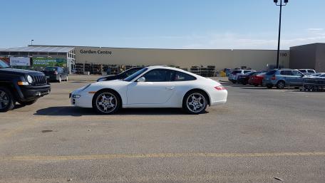 Sleek White Porsche Hardtop in a Parking Lot wallpaper
