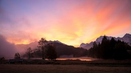 Serene Sunset Over Misty Mountains wallpaper
