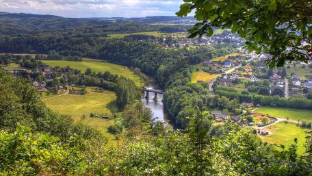 Serene River Valley Landscape With Bridge wallpaper