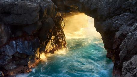 Radiant Ocean Between Rocky Shores wallpaper