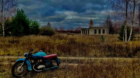 Vintage Motorcycle Amidst a Forgotten Landscape wallpaper
