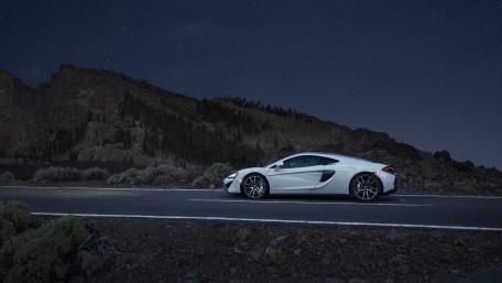 Sleek Car Under a Starry Night Sky wallpaper