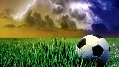 Dynamic Soccer Scene with Stormy Skies wallpaper